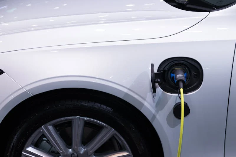 Close-up of EV charging port on white vehicle